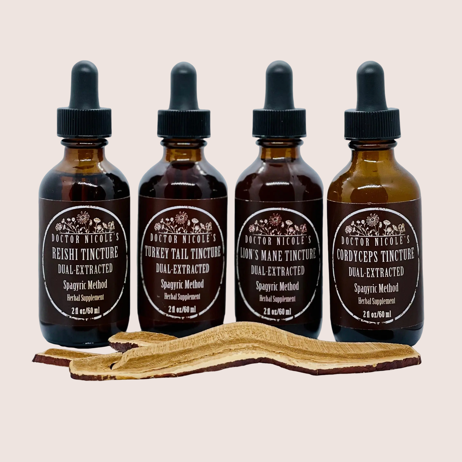 Four bottles of herbal tinctures with a sliced mushroom in front.