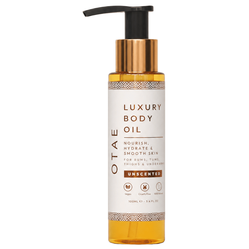 A clear pump bottle of Otae Luxury Body Oil, Unscented, against a white background.
