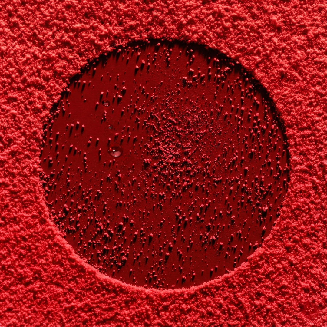 A microscopic close-up image of red particles