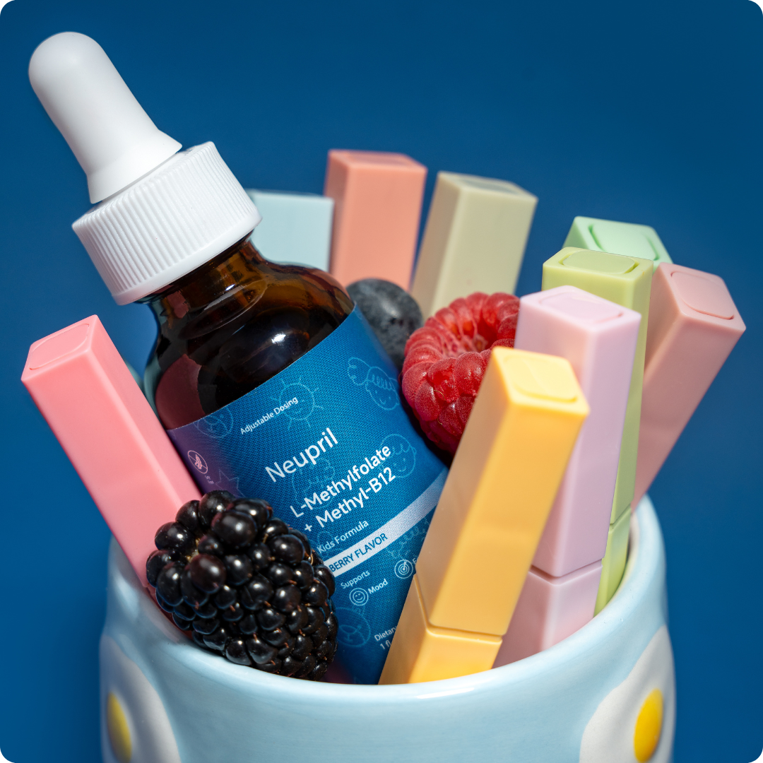 Bottle labeled Neupril surrounded by colorful rectangular items and berries in a cup.