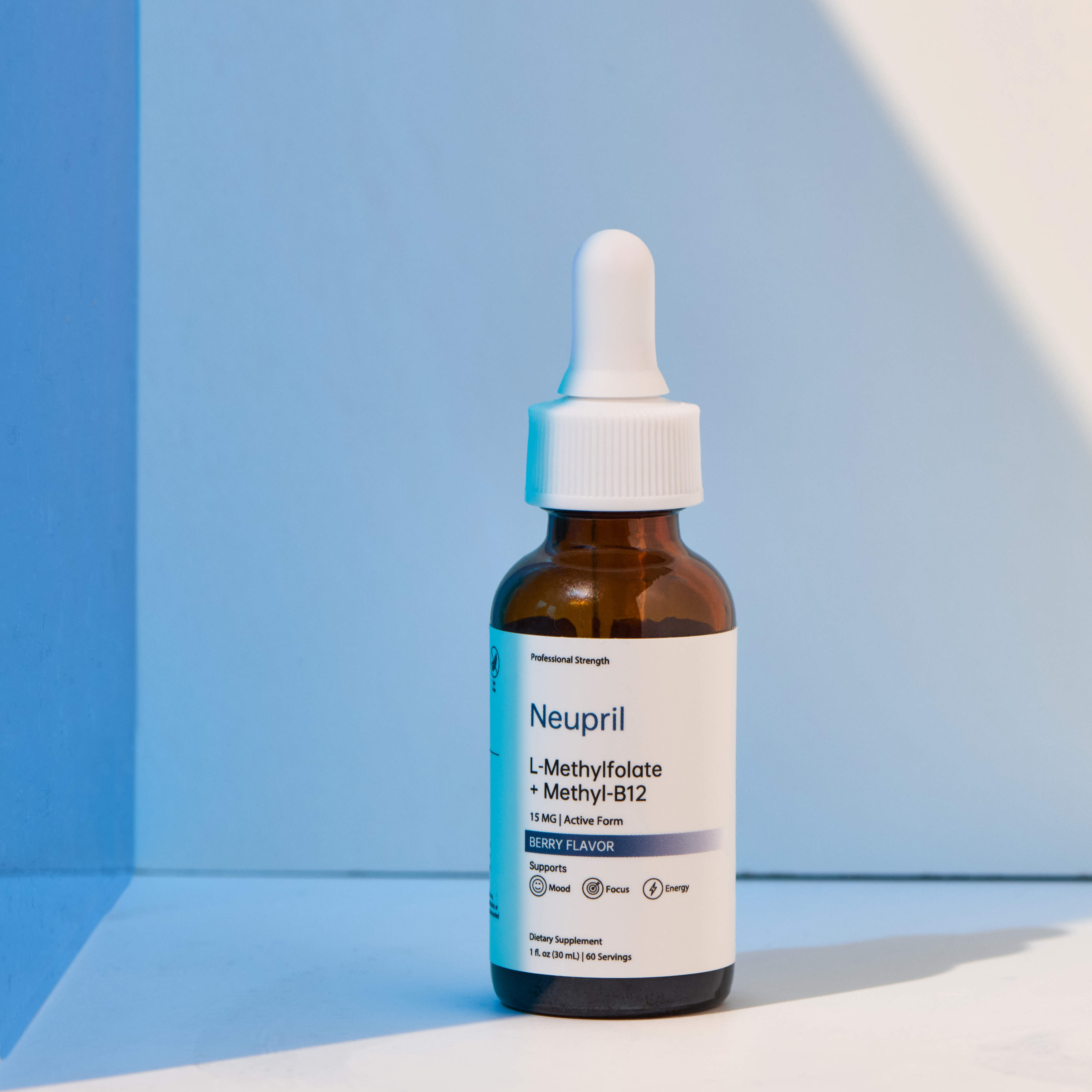 A bottle of Neupril L-Methylfolate + Methyl-B12 supplement with a white dropper standing upright in soft blue and white lighting, highlighting its clean and minimalist design