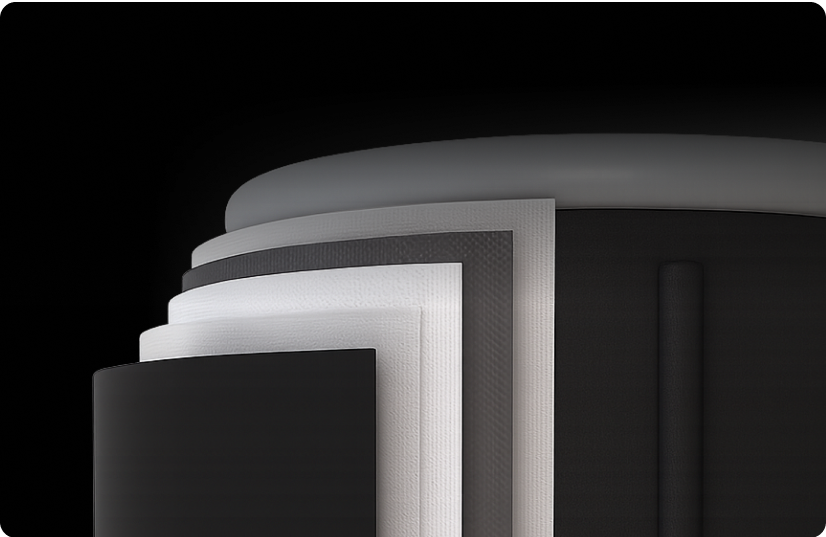A close-up of layered black and white cylindrical shapes on a dark background.