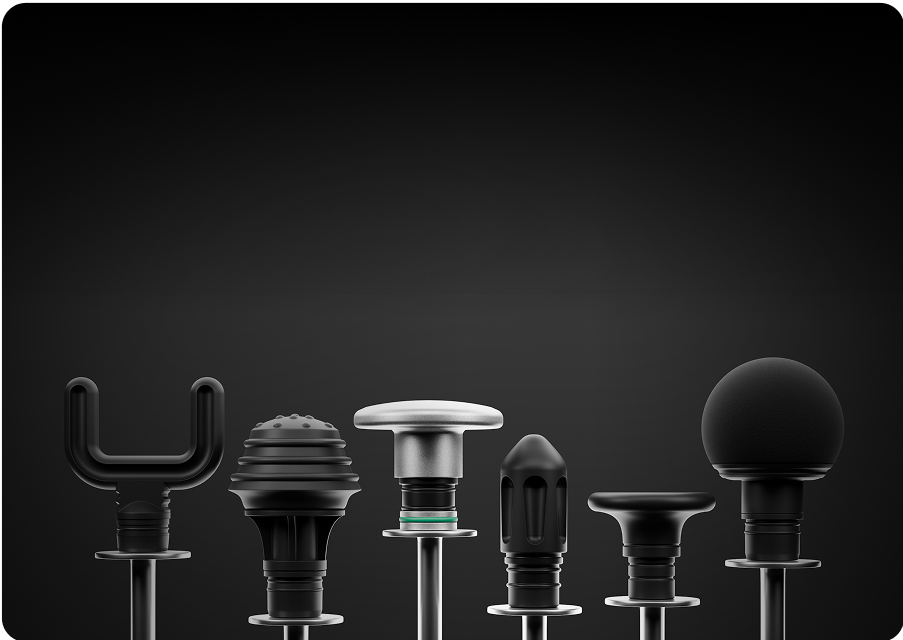 Six different black massage gun attachments on a dark background.