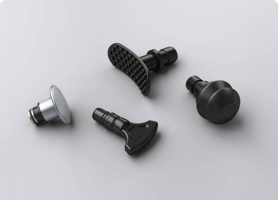 Four different black and silver tool attachments on a light gray surface.