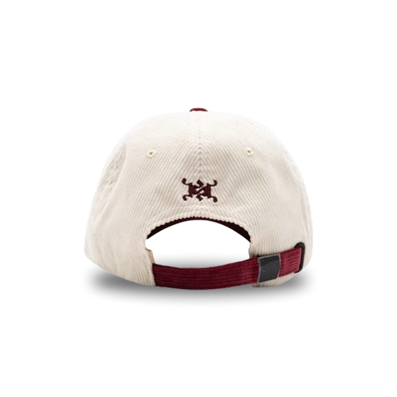 The back of a cream-colored corduroy baseball cap with a maroon adjustable strap and embroidered logo.