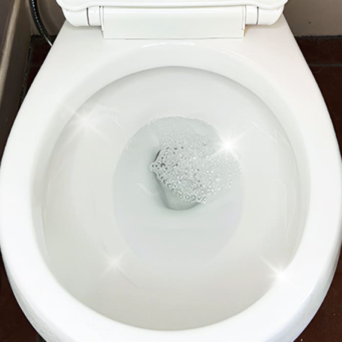 Clean toilet bowl with sparkling water and bubbles.
