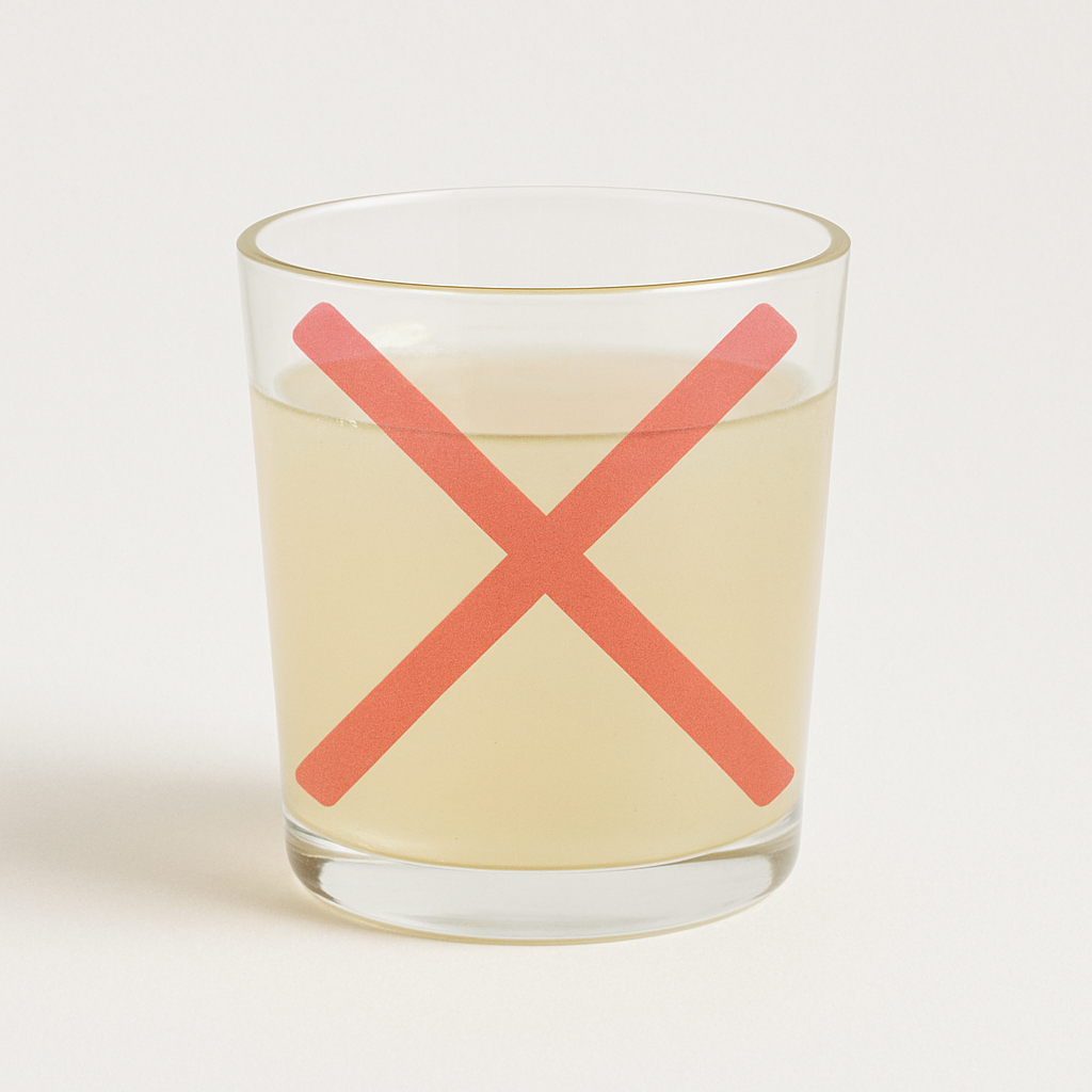 Glass of yellow liquid with a red X on it.