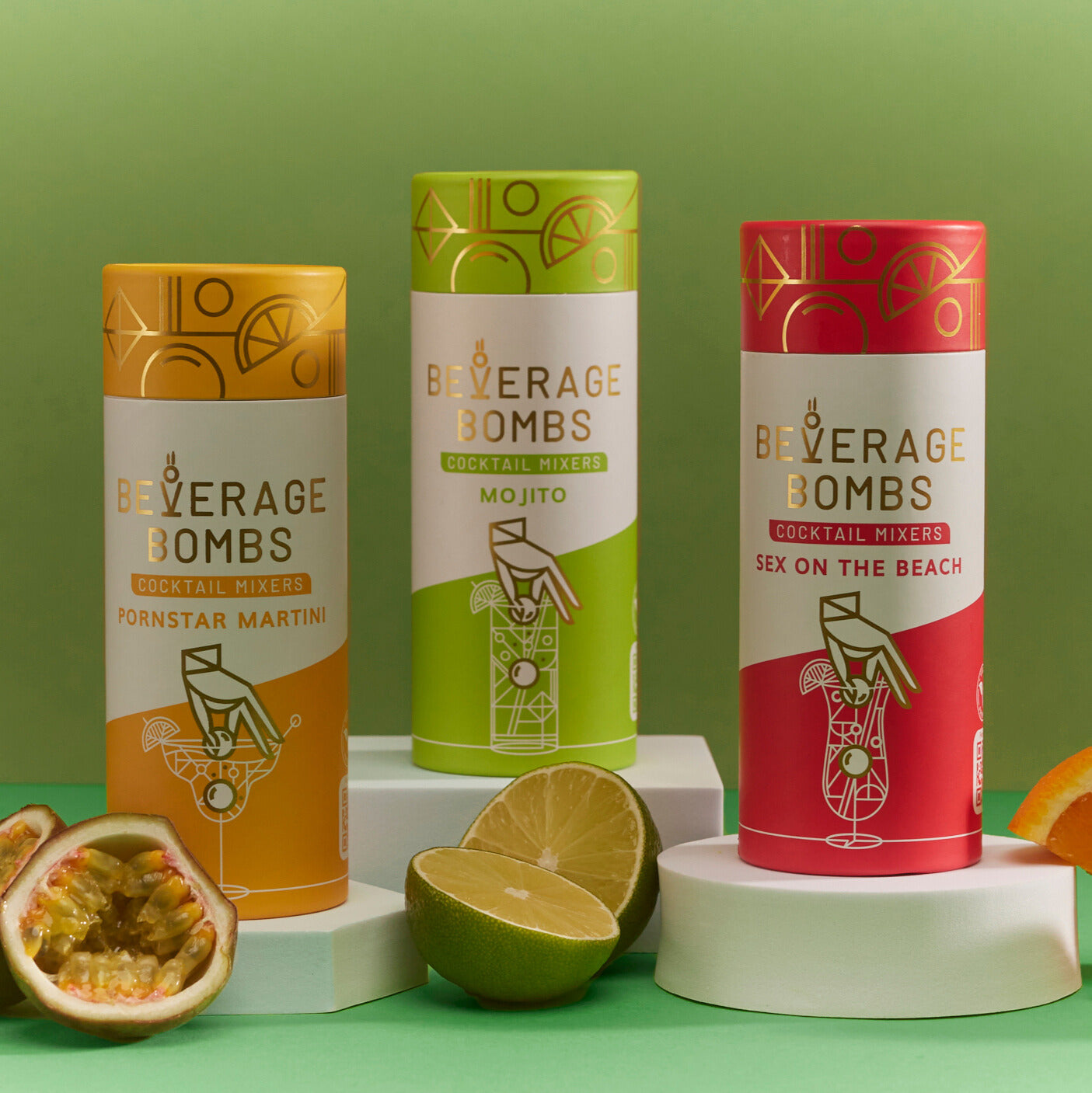 Three cocktail mixer cans with fruit on a green background.