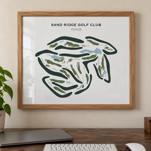 A framed print of the Sand Ridge Golf Club course map hanging on a wall above a desk.