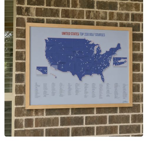 A framed map titled 'United States Top 250 Golf Courses' hanging on a brick wall.