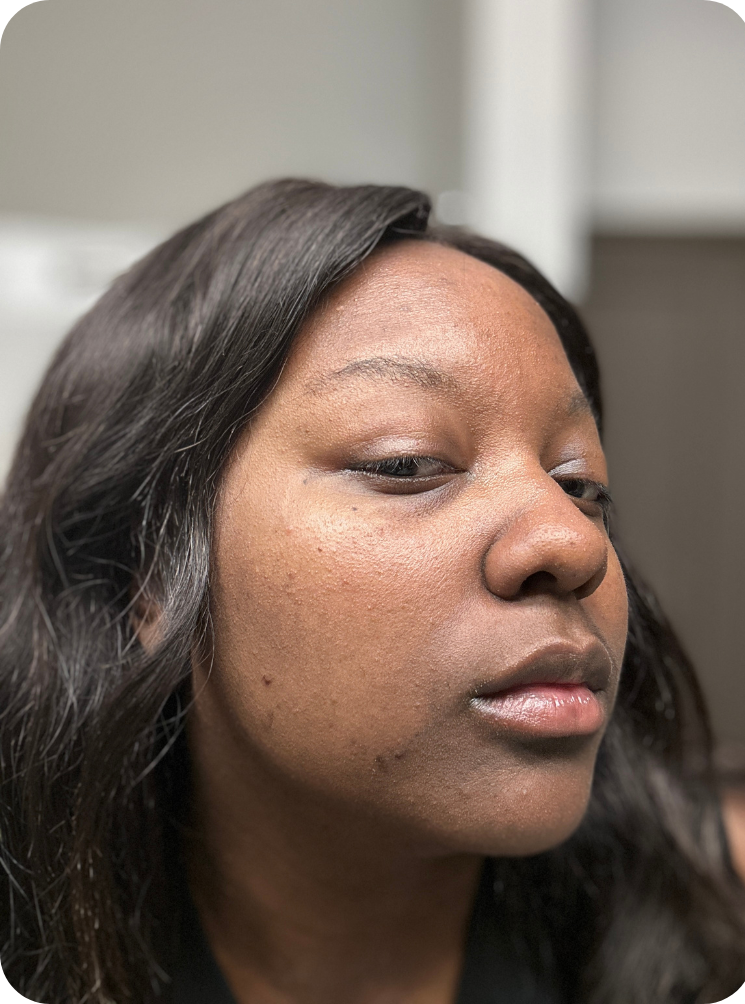Close-up of a person with long dark hair, showing side of their face.