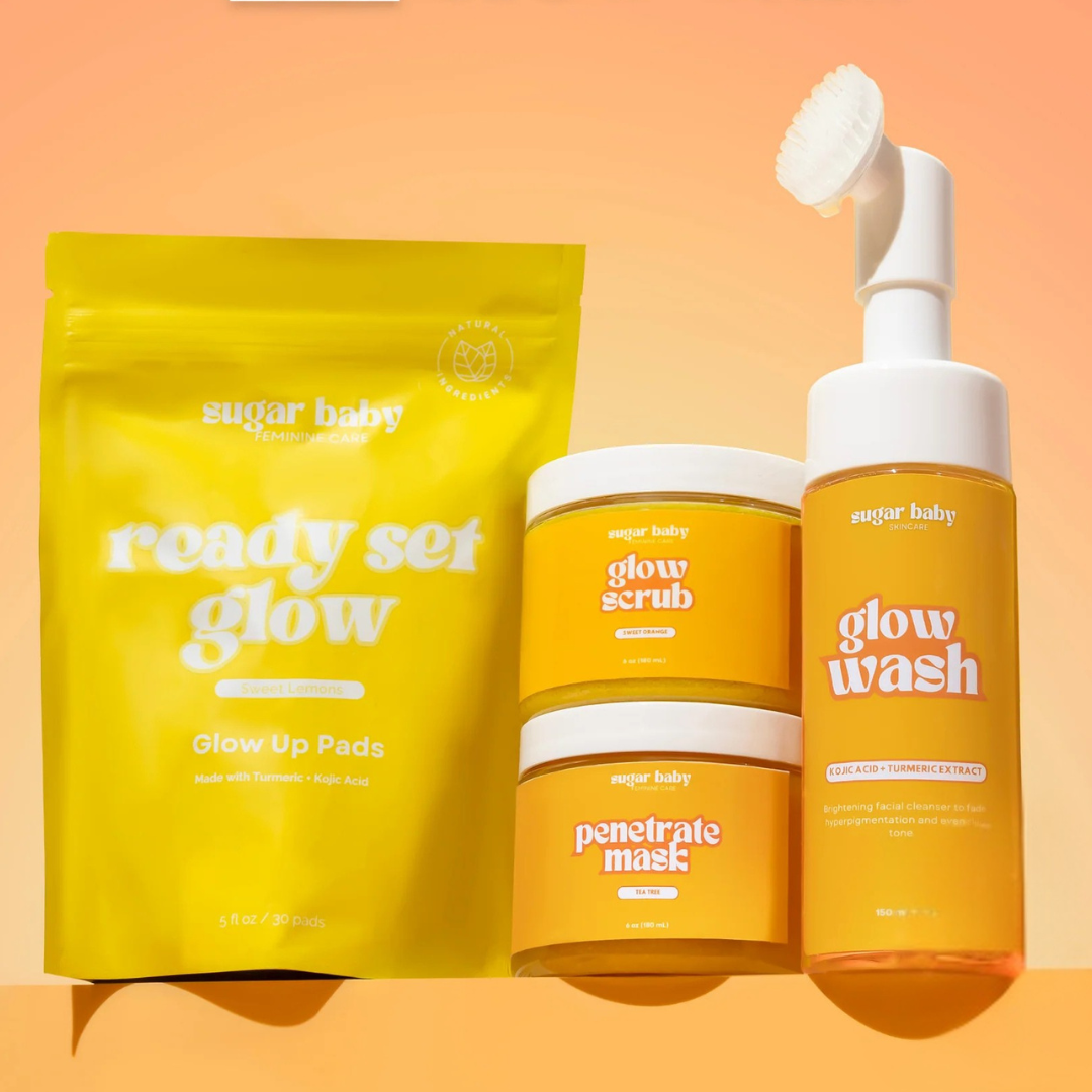 Skincare products including glow pads, scrub, mask, and wash on an orange background.