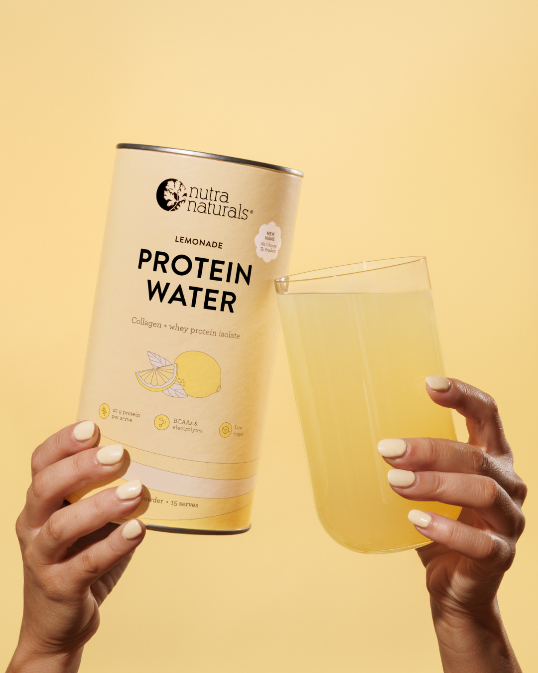 Hands holding a container of Nutra Naturals Lemonade Protein Water and a full glass of the drink.