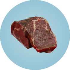 Two pieces of raw red meat against a light blue background.