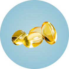 Three yellow gel capsules on a light blue background.