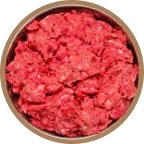 A close-up, top-down view of a bowl filled with raw ground meat.