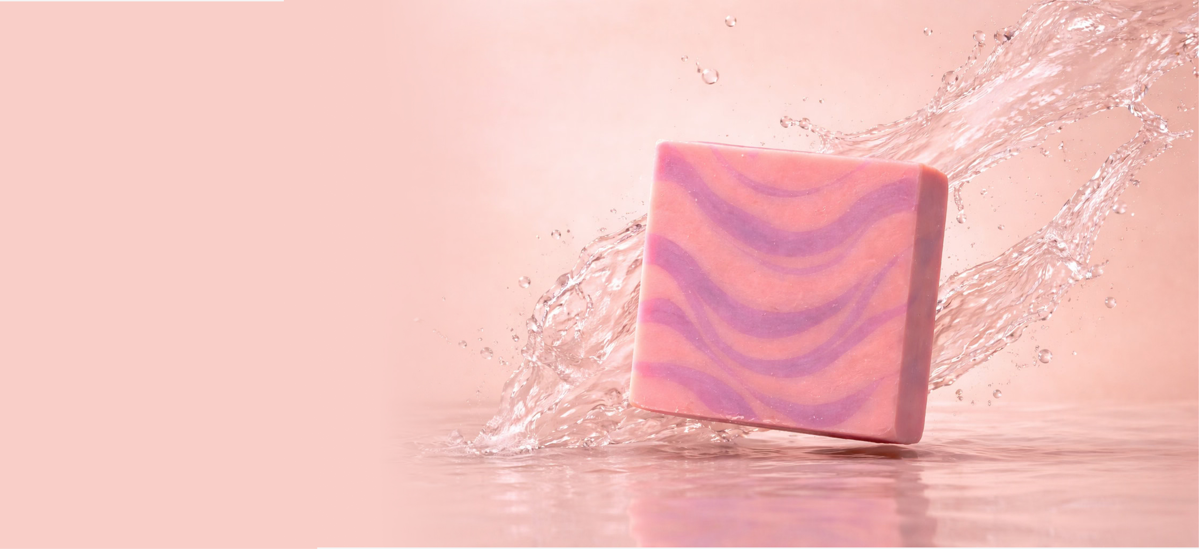 Pink and purple swirled soap with water splashing around it.