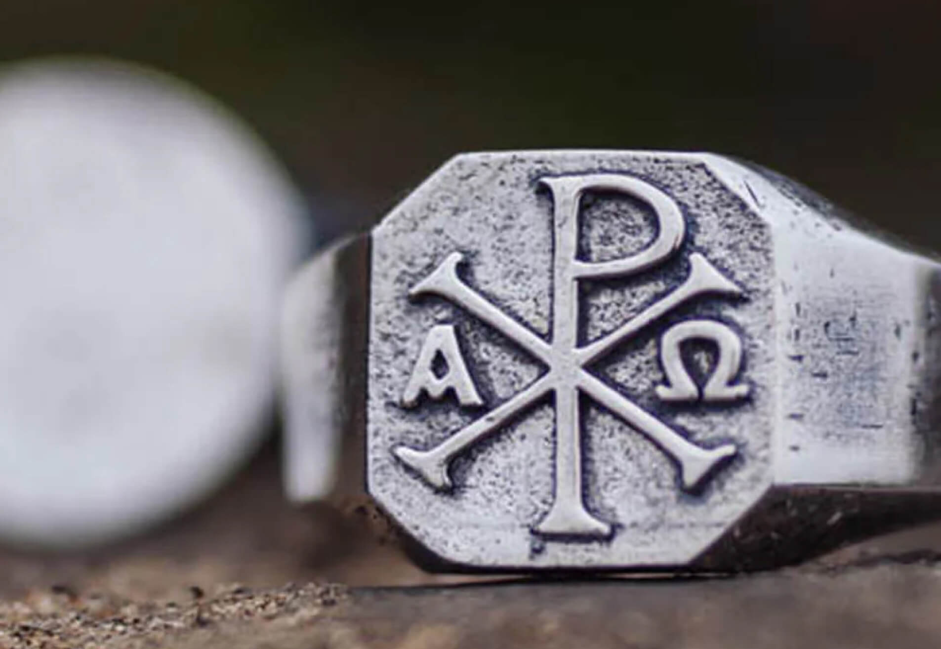 Silver ring with engraved Chi Rho symbol and Greek letters Alpha and Omega.