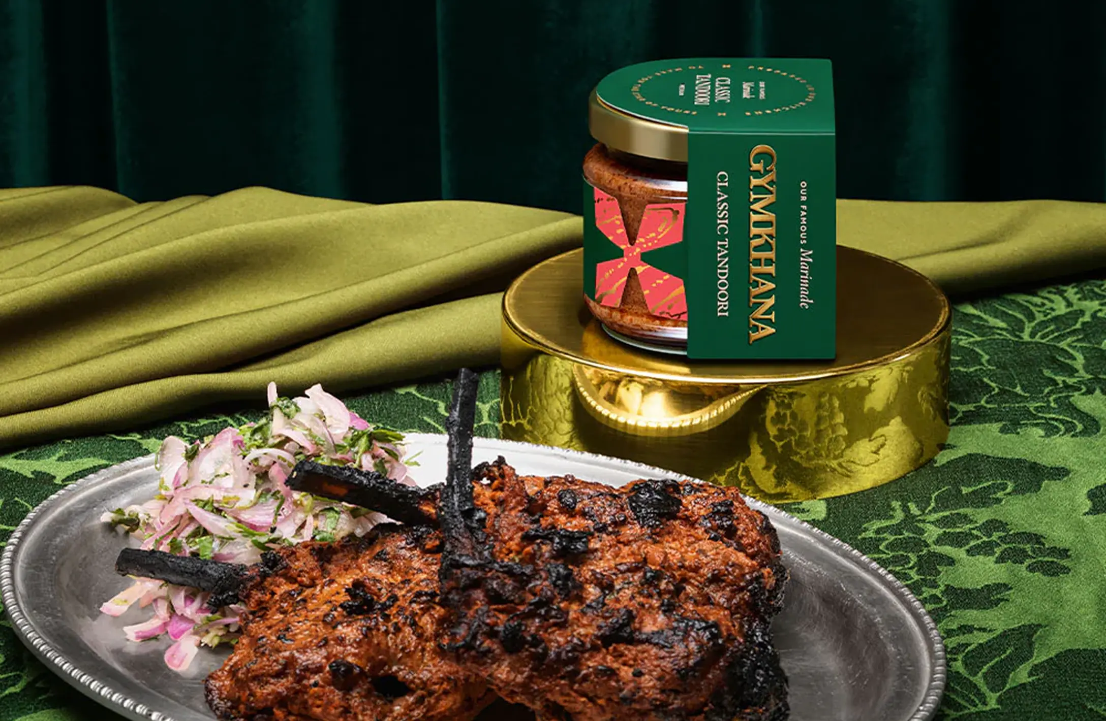 The packaging for Gymkhana Green Tikka Chicken Breasts, showing the cooked dish on a silver platter.