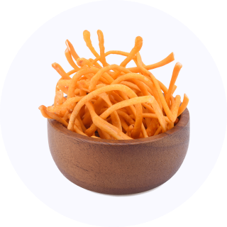 A wooden bowl filled with orange, crispy snack sticks.