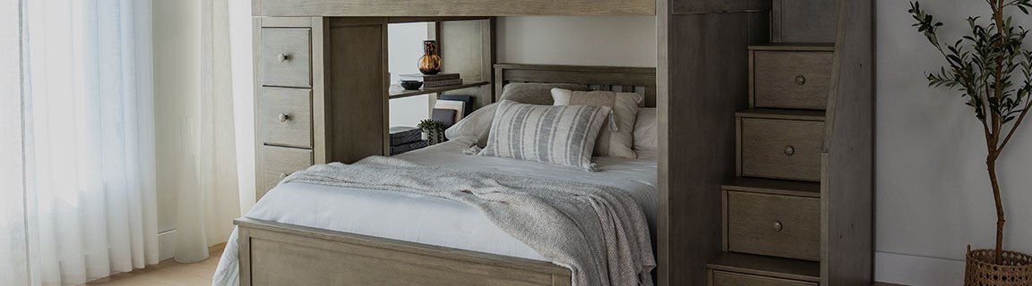Stylish wooden loft bed with drawers and staircase in modern bedroom design.