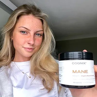 Young blond woman holding Cognix MANE 
Supplement jar