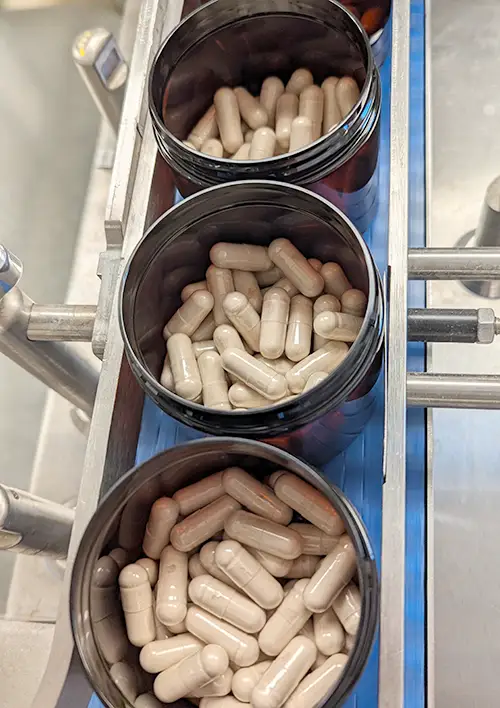 Open jars photo containing Cognix RSE Capsules during manufacturing