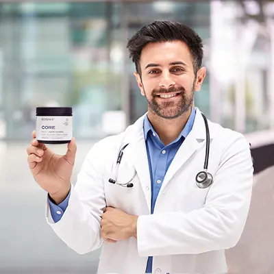 Smiling doctor holding a container labeled 'CORE' with a stethoscope around his neck.