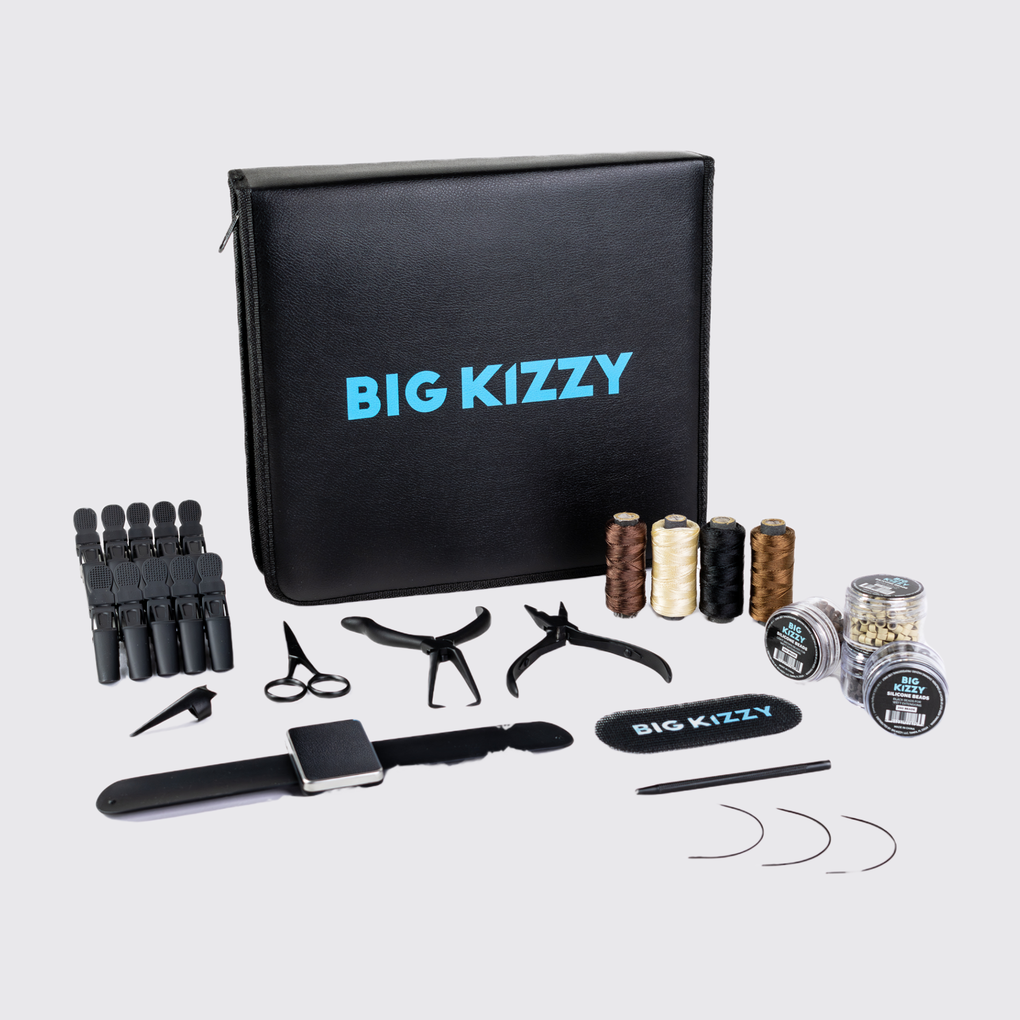 Hair extension tools and accessories with a 'Big Kizzy' branded case.