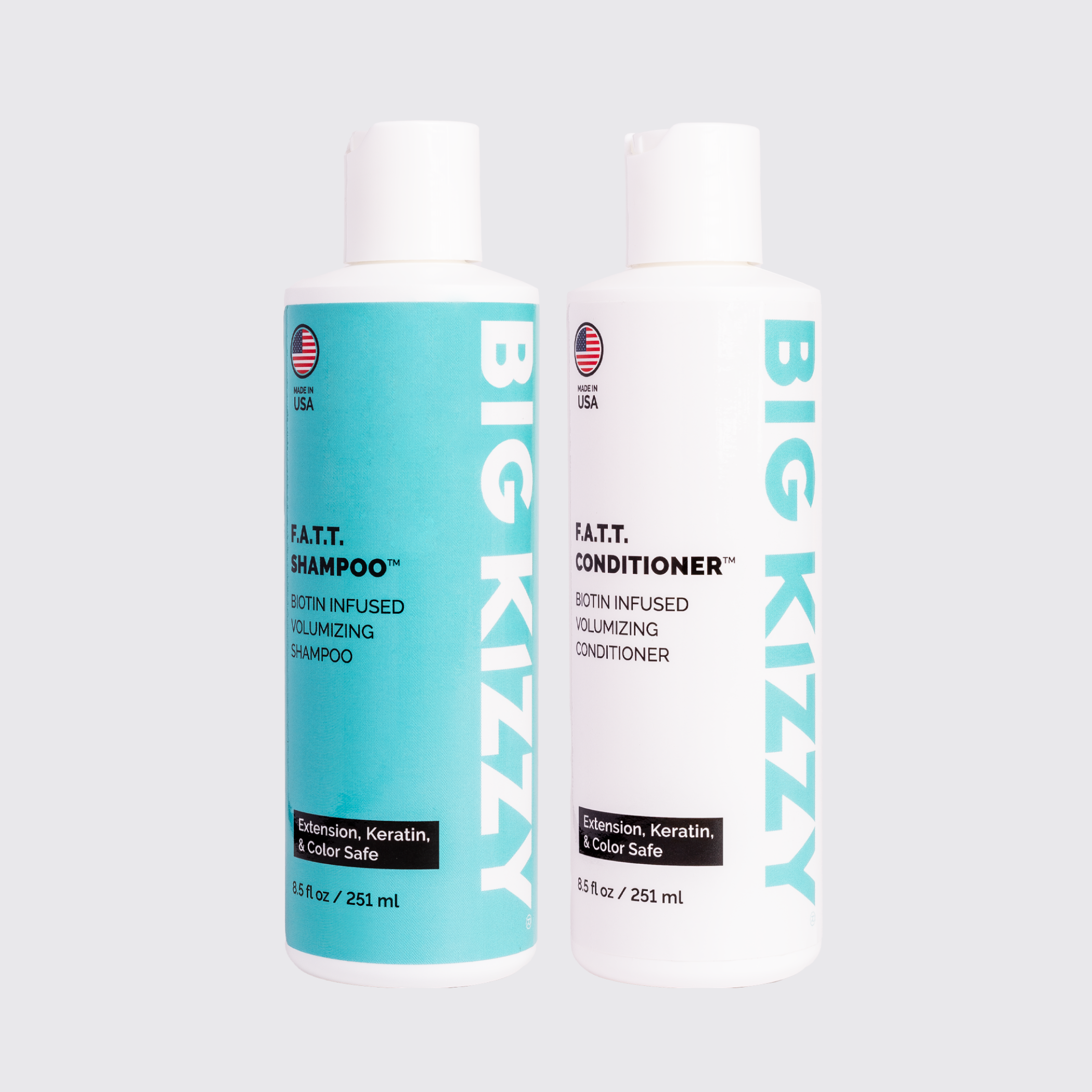 Two bottles of Big Kizzy shampoo and conditioner on a plain background.