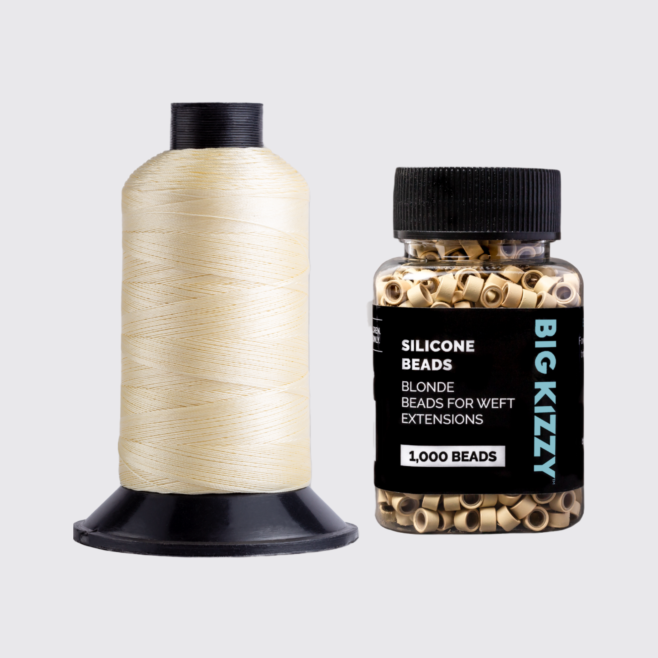 Spool of thread and jar of silicone beads for hair extensions.