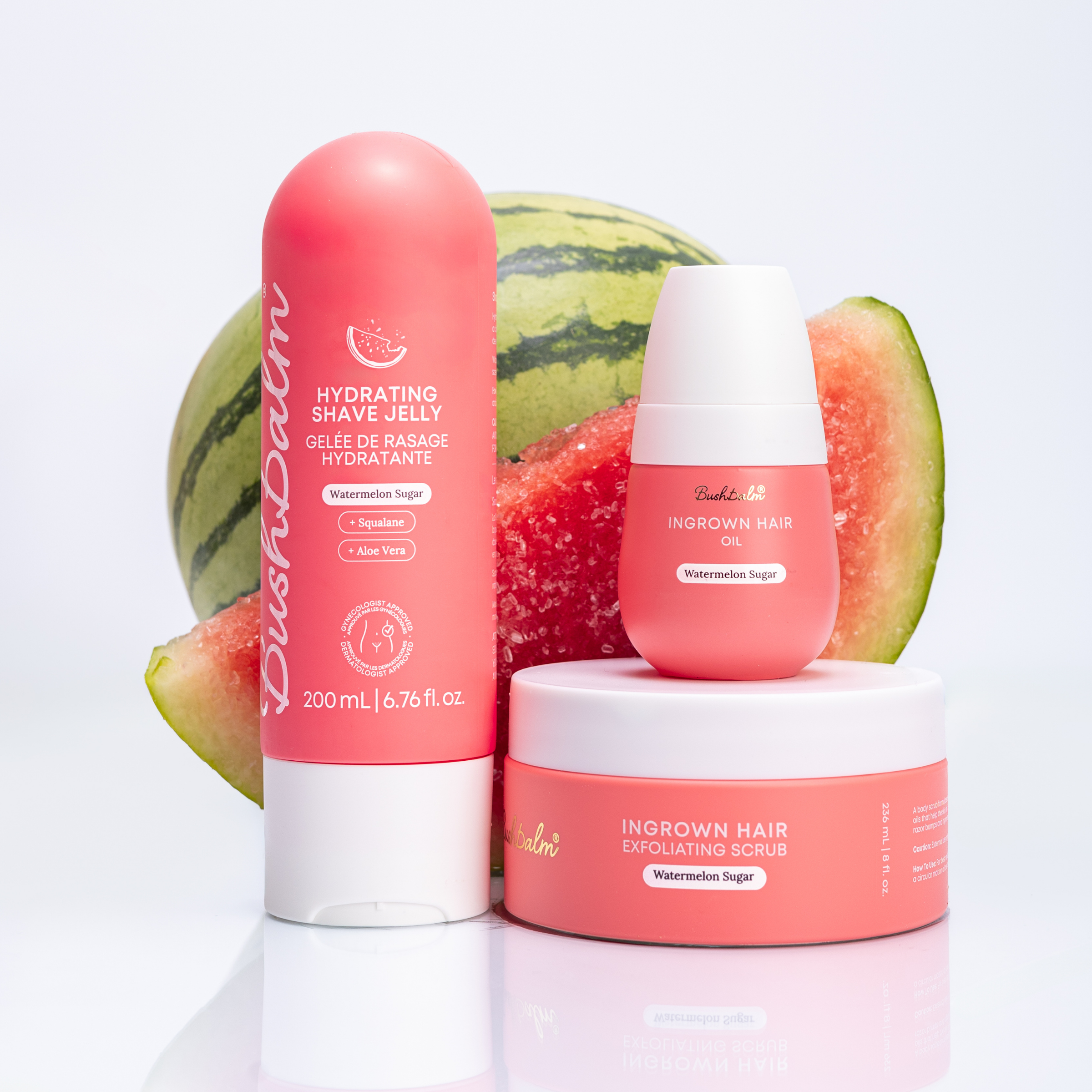 Bushbalm watermelon-scented skincare products—shave jelly, oil, and scrub—arranged with fresh watermelon slices.