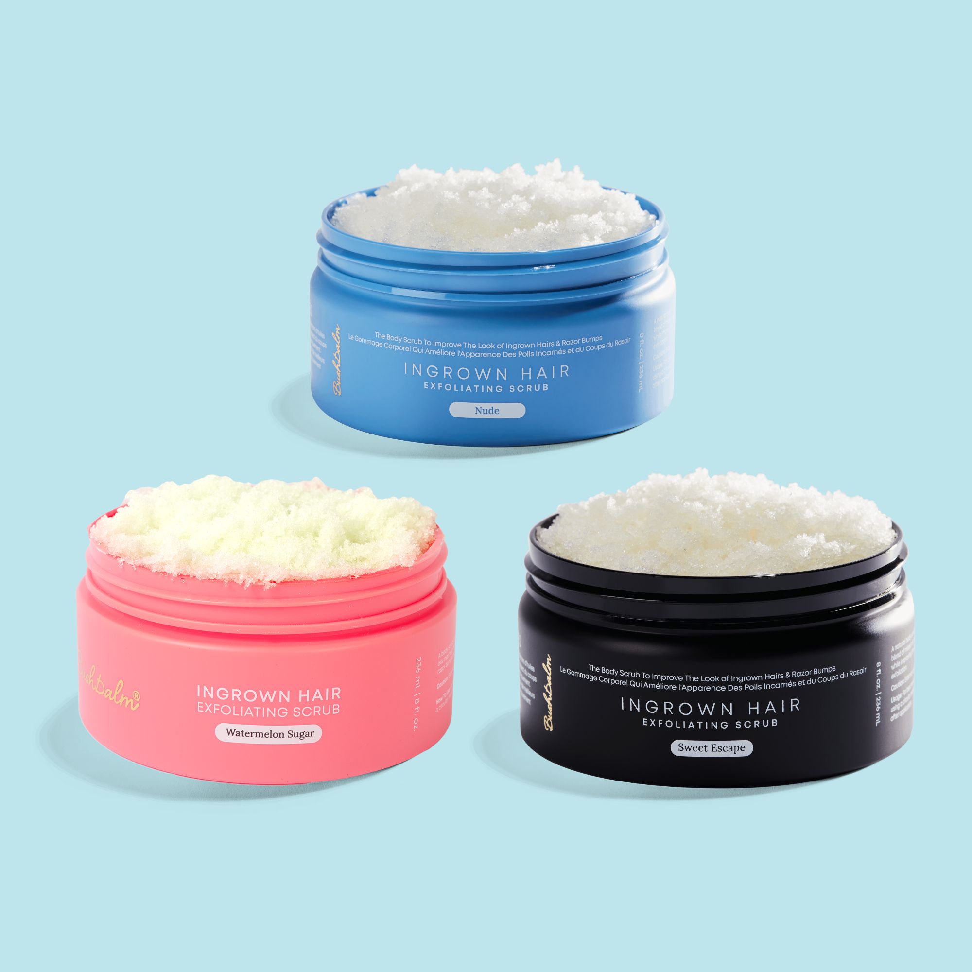 Three jars of exfoliating scrub in blue, pink, and black containers.