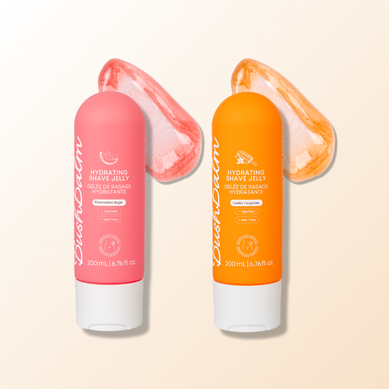 Two tubes of BushBalm Hydrating Shave Jelly in pink and orange, with swatches of the product behind them.