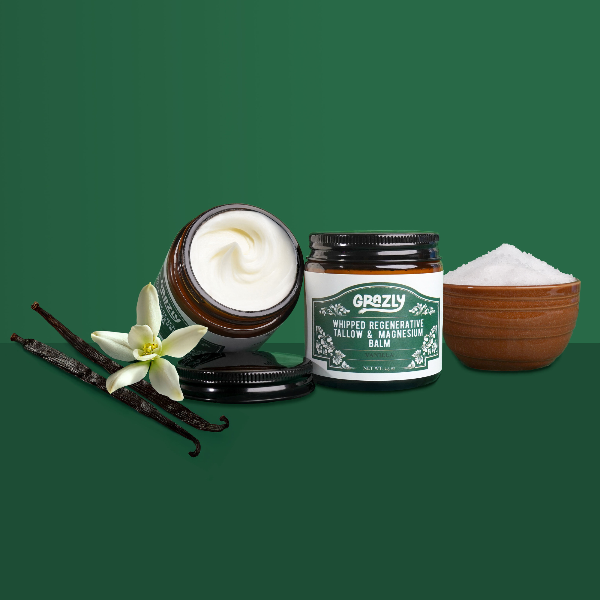 Tallow and magnesium balm jars with vanilla flower and a bowl of white powder.