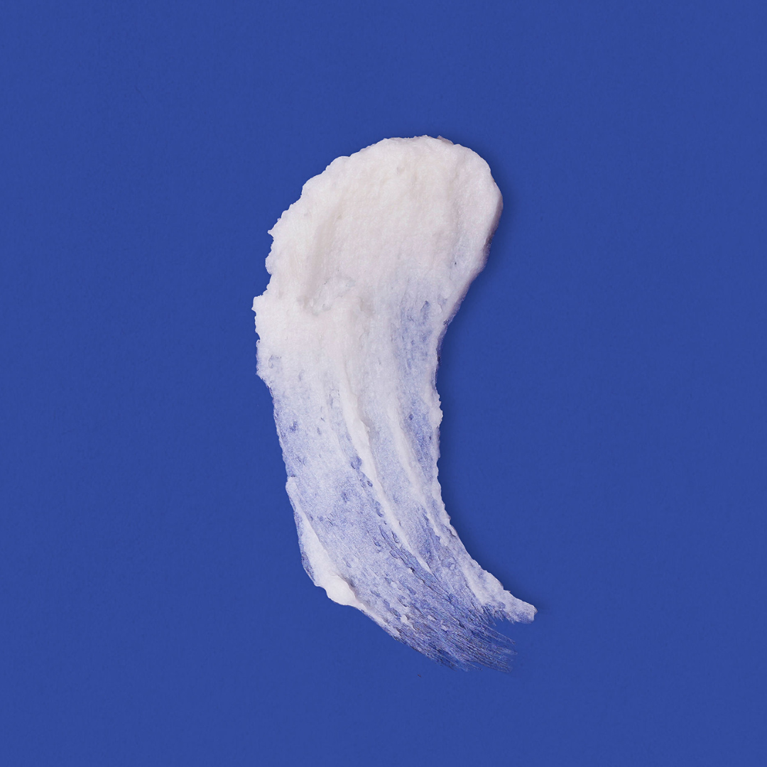 White cream smear on a blue background.
