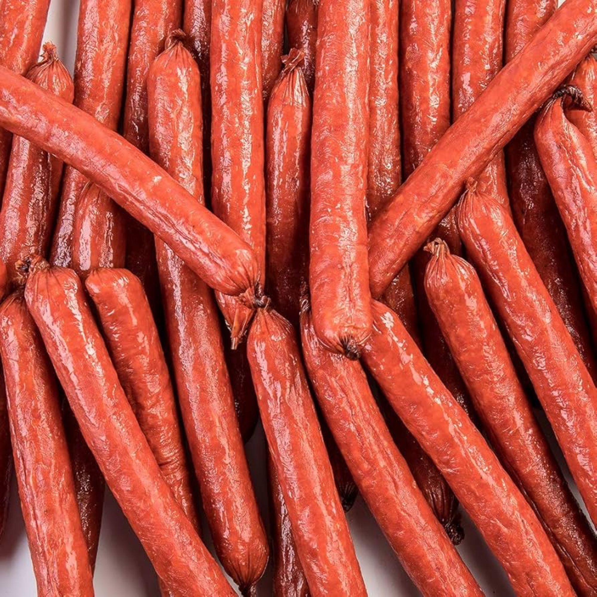 A pile of red sausages arranged closely together.