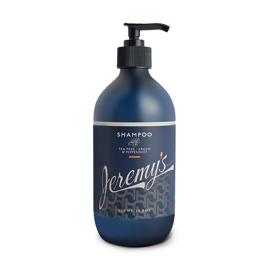Dark blue shampoo bottle with pump, labeled 'Jeremy's' and ingredients listed.