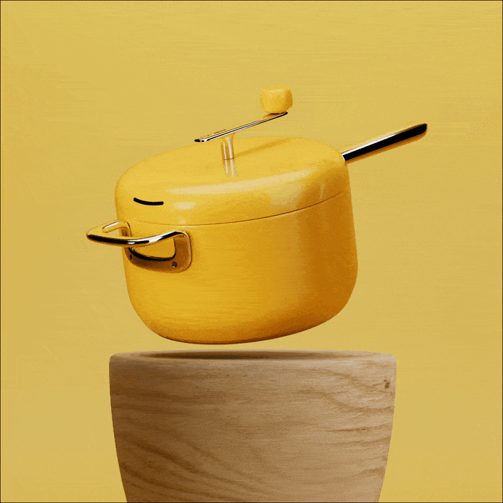Yellow saucepan with lid floating above a wooden surface.