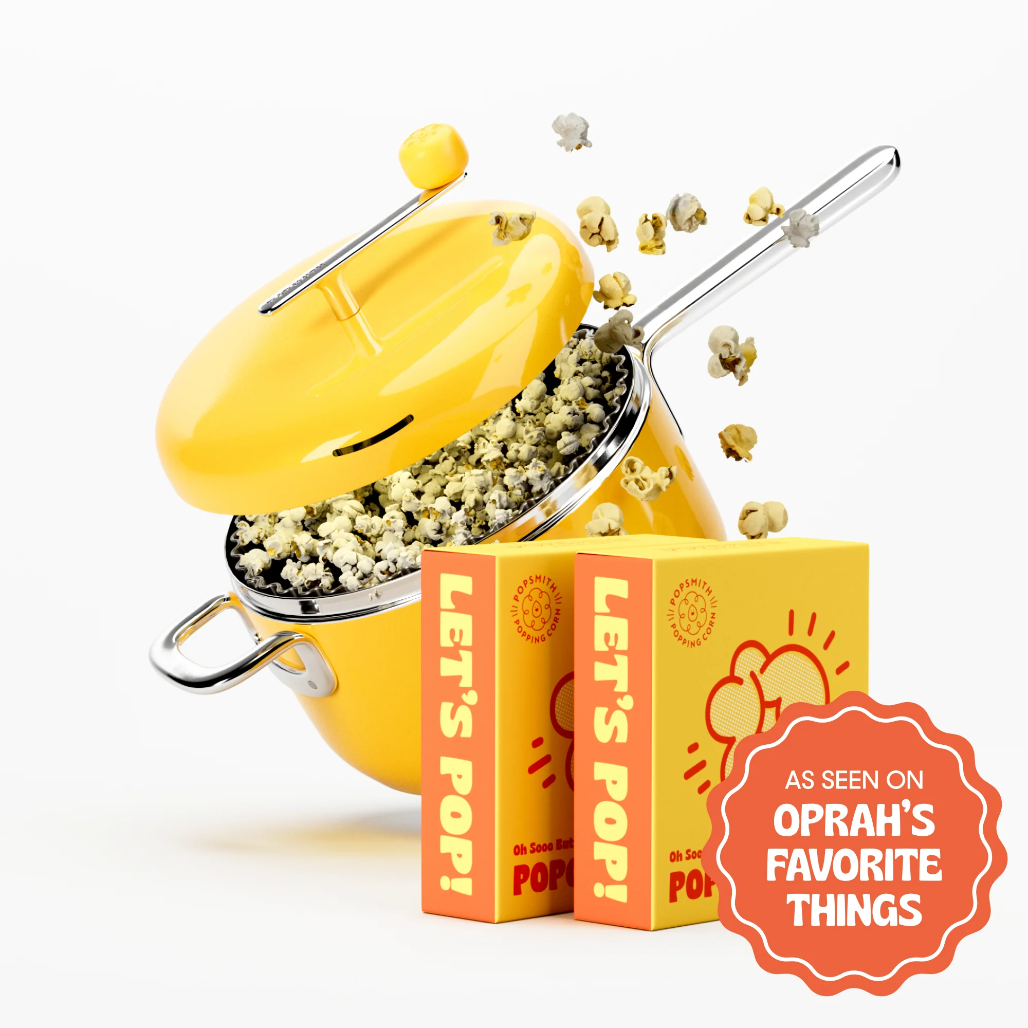 A yellow stovetop popcorn popper overflowing with popcorn, next to two boxes of popcorn kernels.