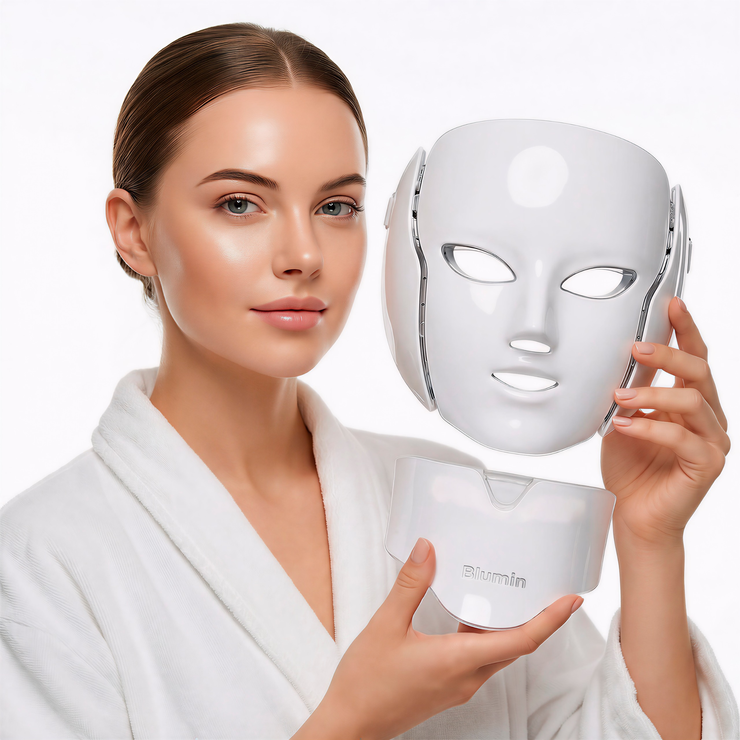 A woman in a white bathrobe holding a white, two-piece LED light therapy facial mask.