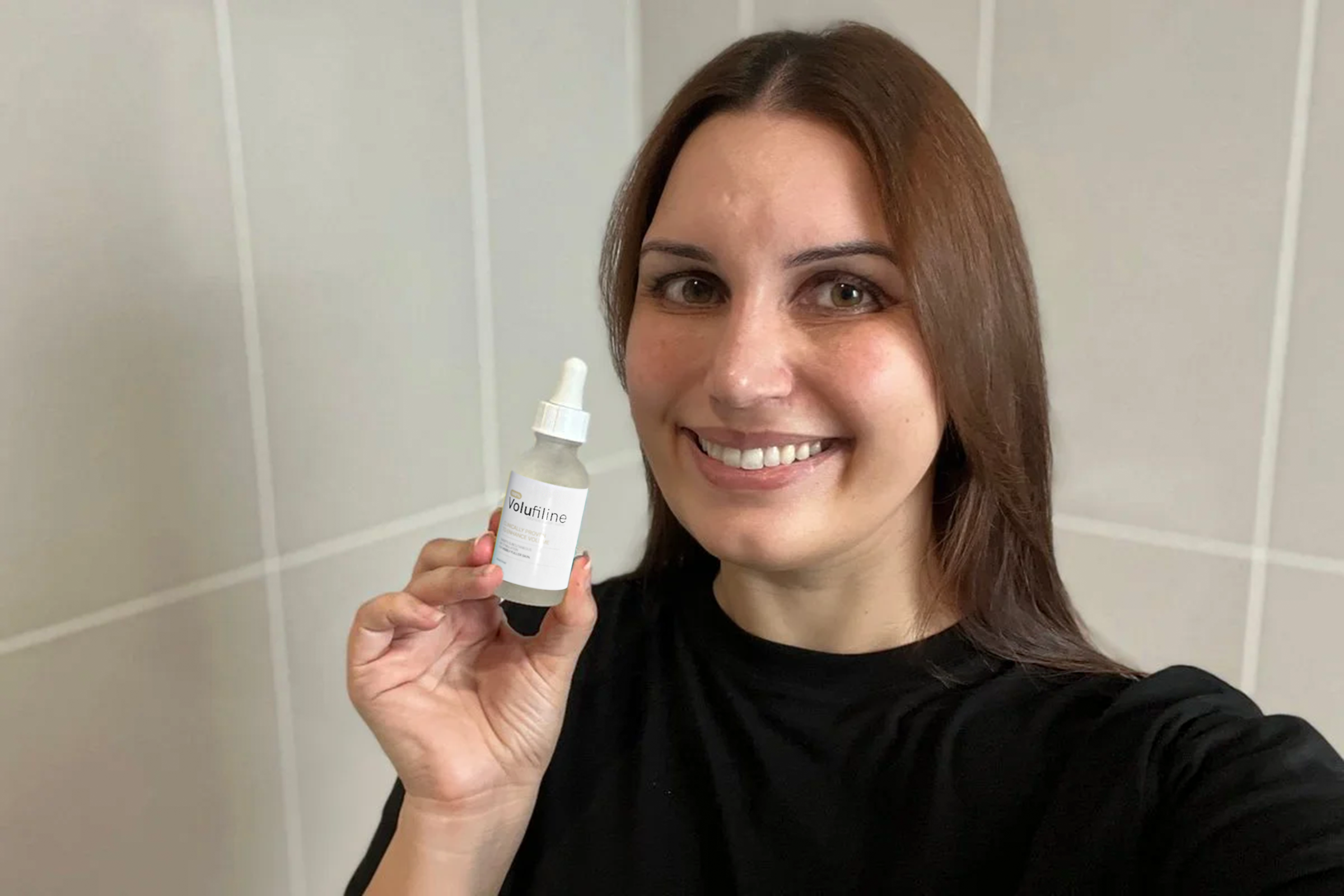 Woman smiling and holding a bottle labeled 'Volufiline' in her hand.