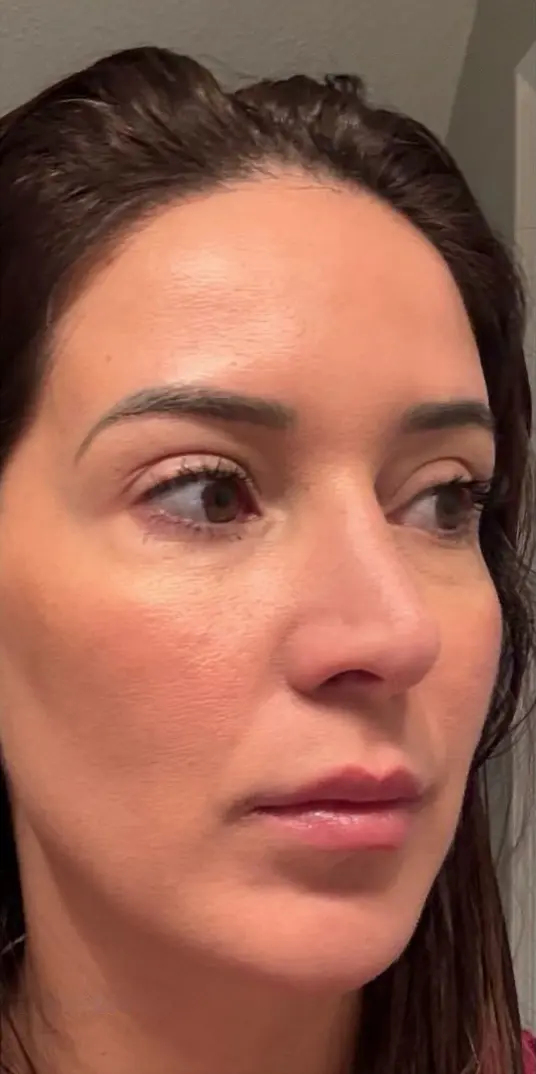 Close-up of a person looking to the side, with a neutral expression.