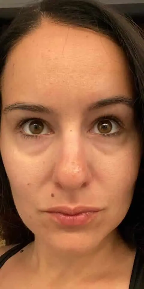 Close-up of a person with a neutral expression, looking directly at the camera.