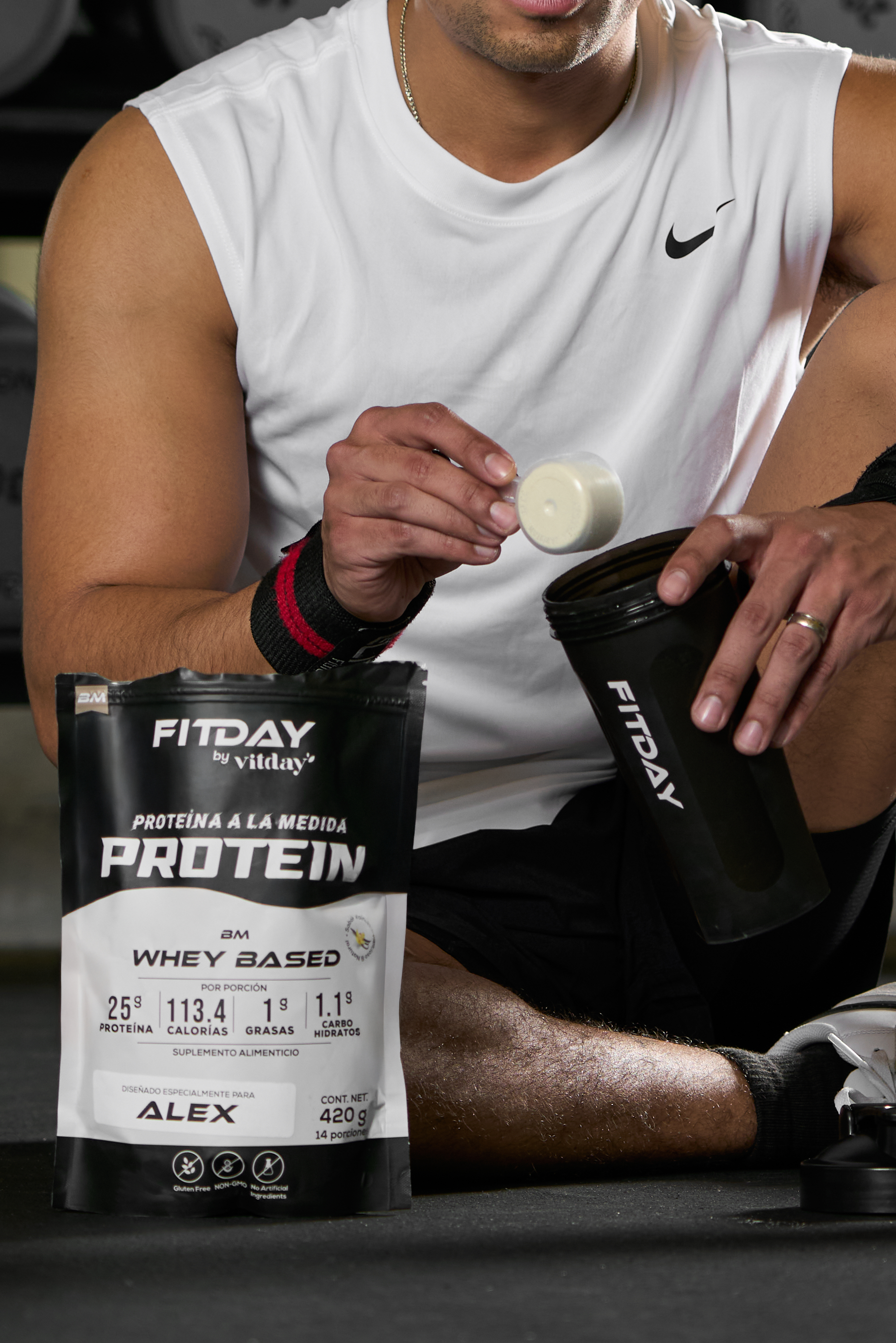 Person preparing protein shake with Fitday whey protein.