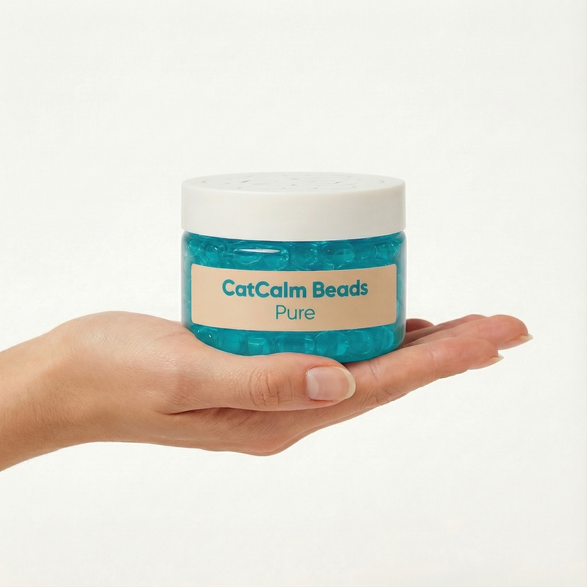A hand holding a clear jar of blue CatCalm Beads against a white background.