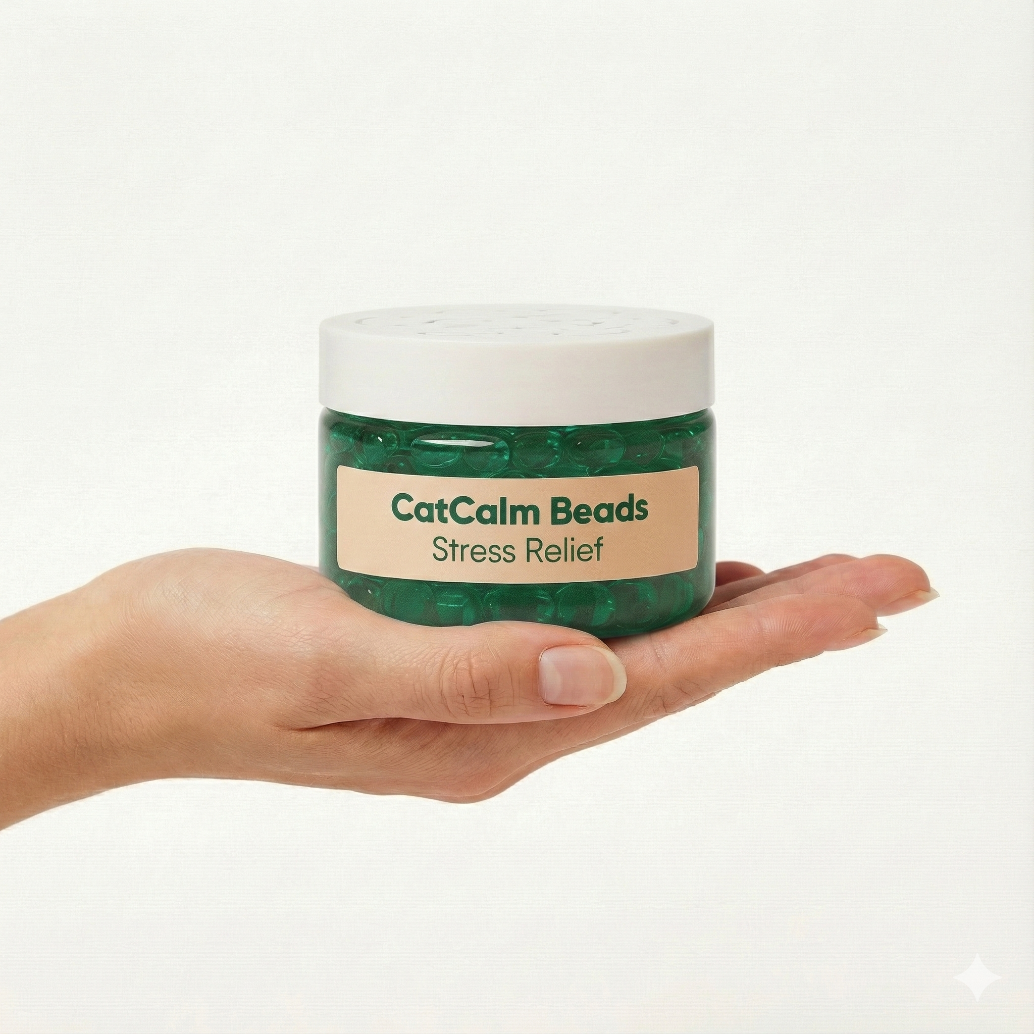 A person's hand holds a jar of 'CatCalm Beads Stress Relief' filled with green gel beads.