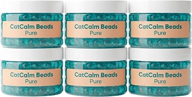 Six clear jars with white lids, labeled 'CatCalm Beads Pure,' filled with small turquoise beads.
