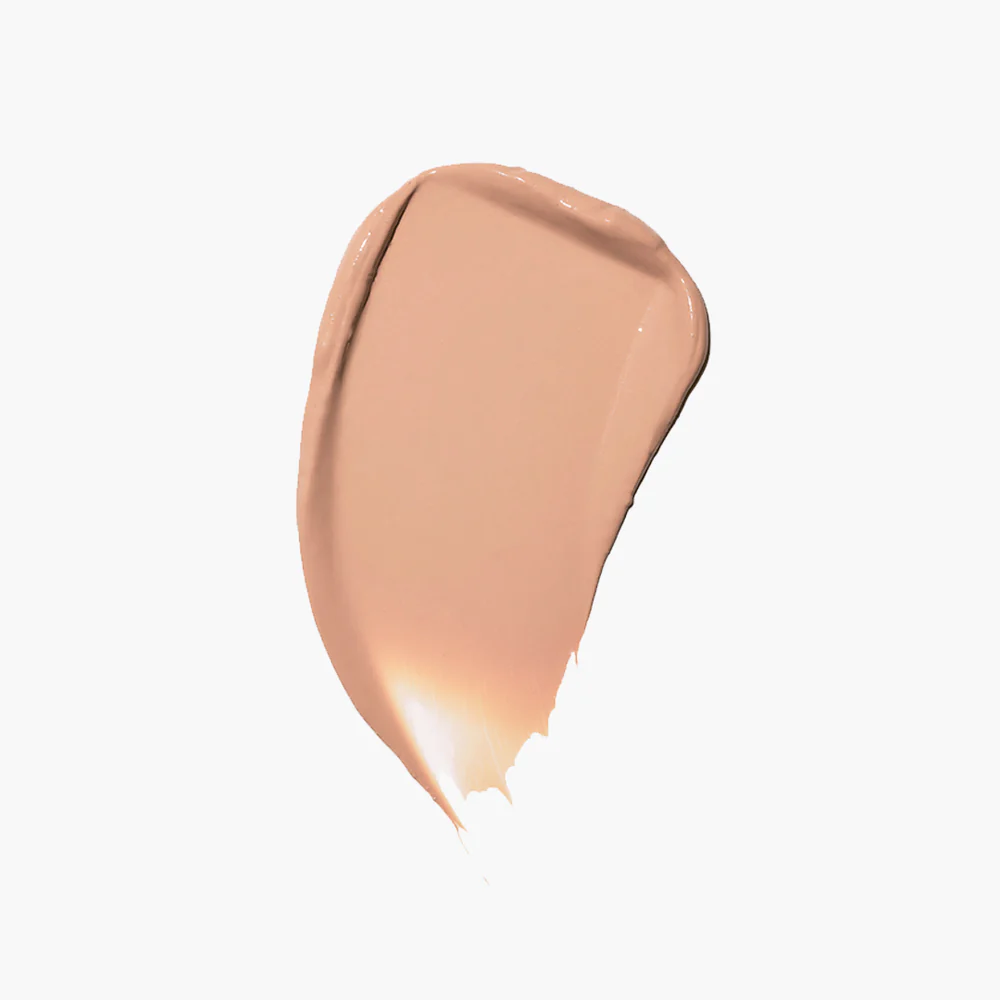 A smear of beige makeup on a white background.