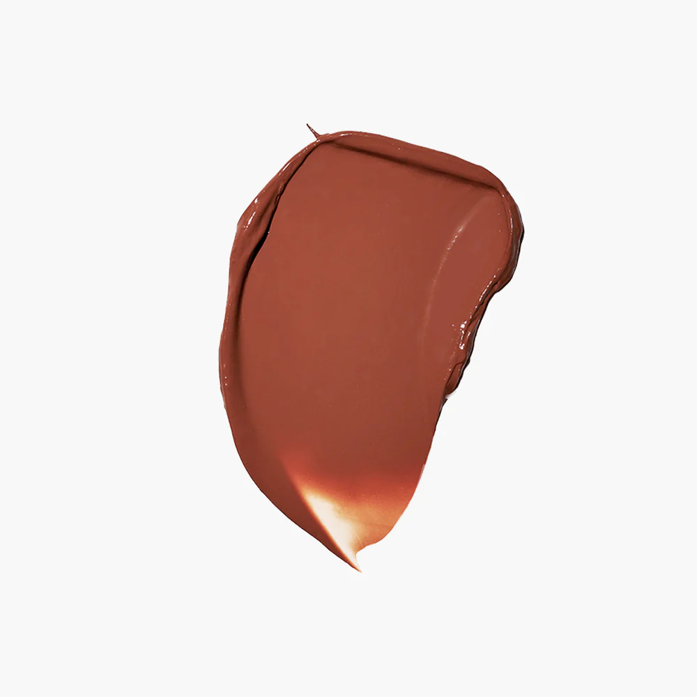 A smear of brownish-red cream on a white background.